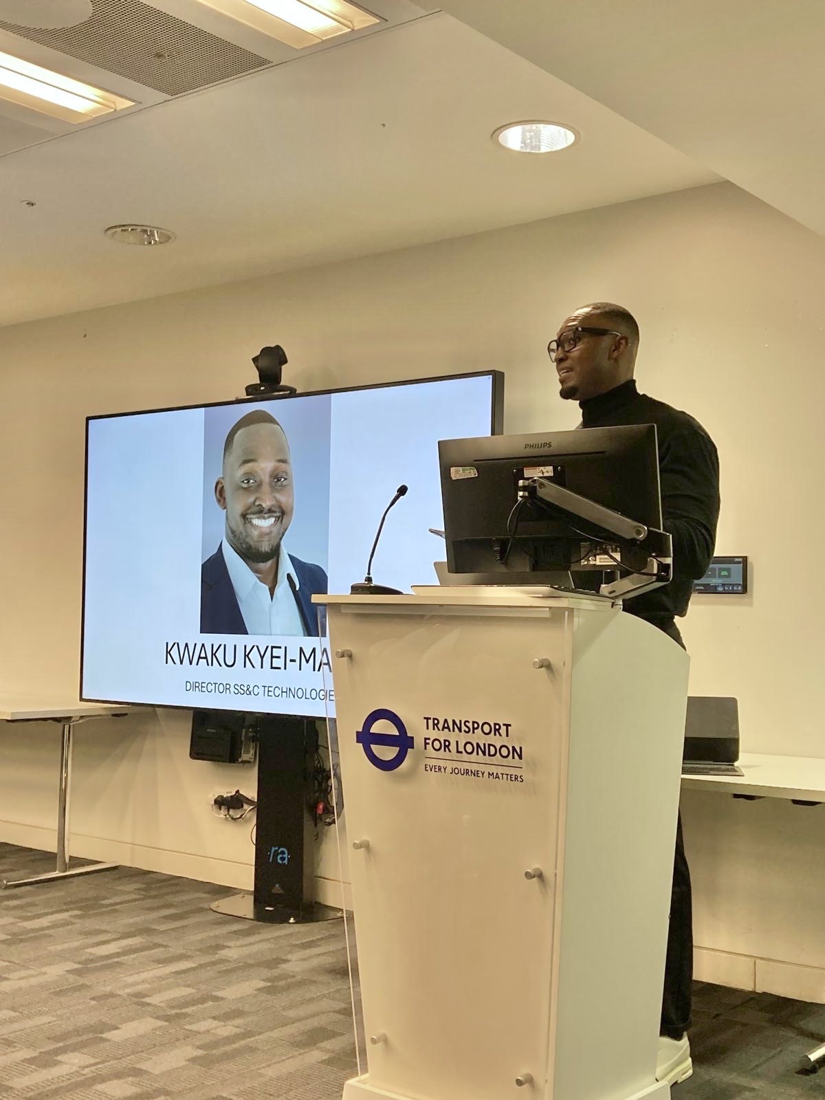 Kwaku Kyei-Manu speaking at a Transport for London lectern.